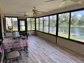New flooring and acrylic sliders installed in sun room in Iona, FL