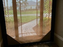 Hurricane screen protecting doorway at a home on SW 23rd pl 33914