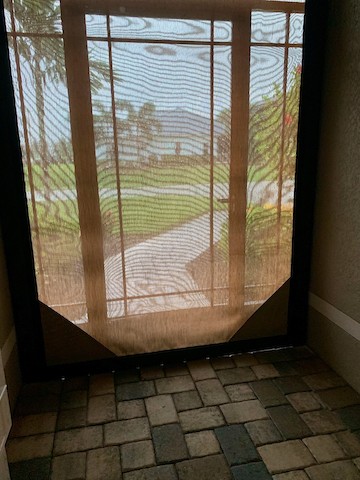 Hurricane screen protecting doorway at a home on SW 23rd pl 33914