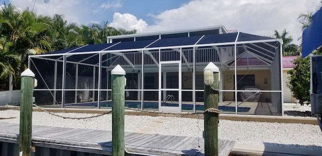 View of pool cage from boat dock on Ft Myers Beach